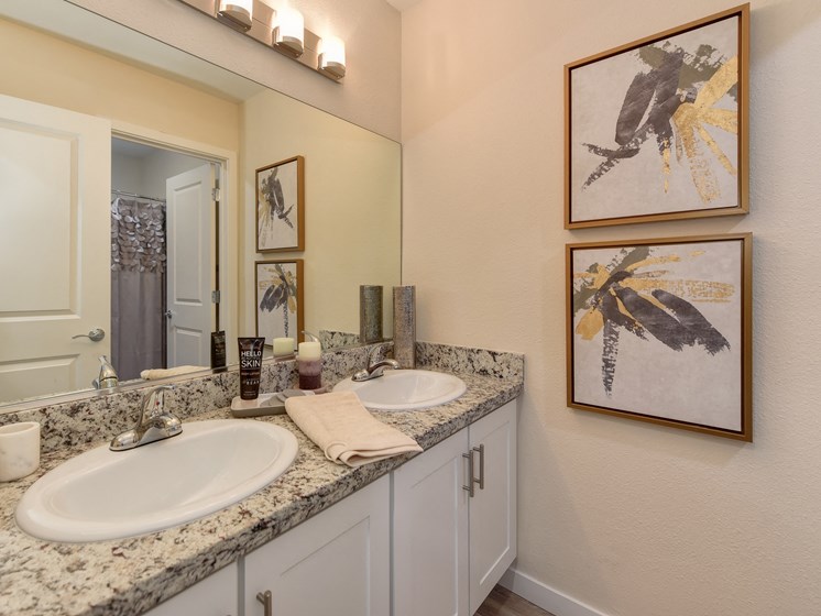 Bathroom with Granite Countertops, Vanity and Framed Abstract Paintings